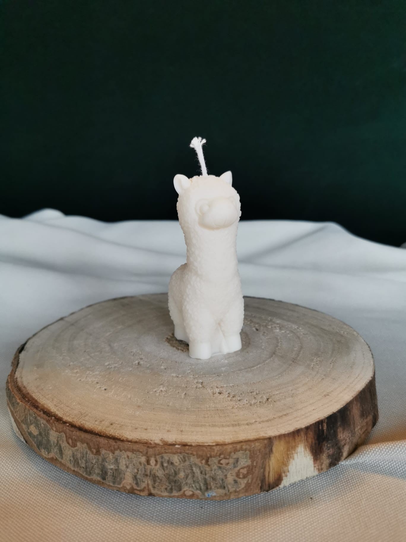 „Handgemachte Lama-Kerze aus cremefarbenem Rapswachs auf Holzscheibe – dekorative Formkerze als Geschenk und Boho-Deko“